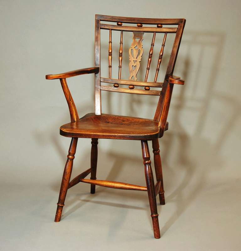 An excellent & unusual example of an early 19th century Mendlesham chair made of fruitwood with an elm seat of good patina (color). 

The fruitwood is possibly plum (due to the variation of wood color on the arms).

The back has a central