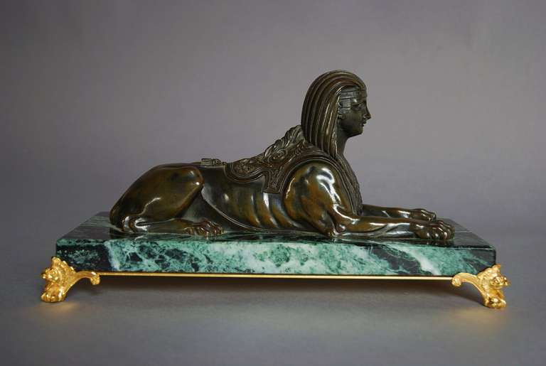 A mid 19th century fine quality bronze figure of a sphinx set on a green marble base with ormolu scroll feet. 

The sphinx is finely cast and is most probably of French origin, the scroll feet being a later addition. 

The sphinx consists of the