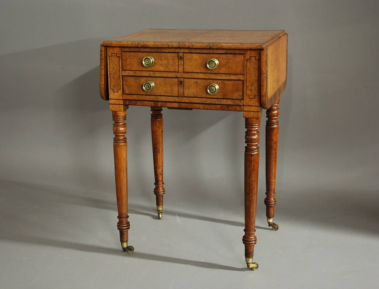 An early 19th century burr oak freestanding work table in the pembroke style of superb patina (color) and good proportions.

The top consists of four Fine quality burr oak panels with mahogany and boxwood stringing, banding and a burr oak