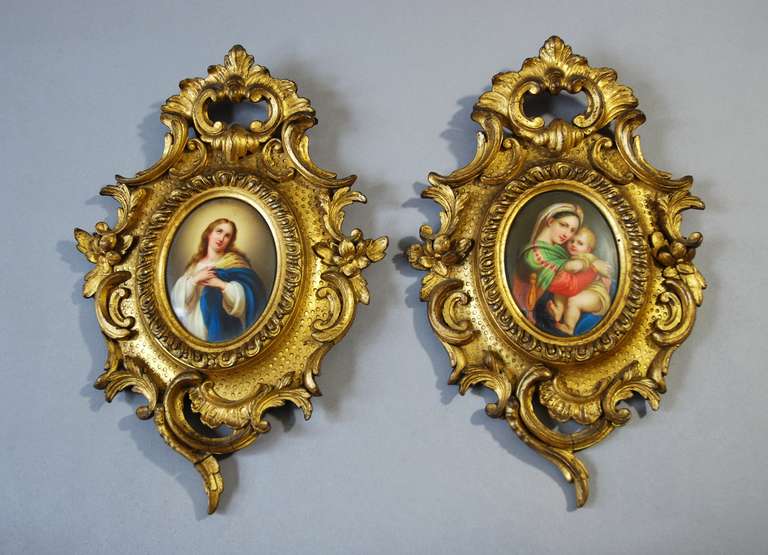 19th century finely painted religious pair of miniature Italian Grand Tour oval porcelain plaques. These are very fine examples and the plaques are framed in highly decorative Rococo style wood and gesso frames. The condition of both the porcelain
