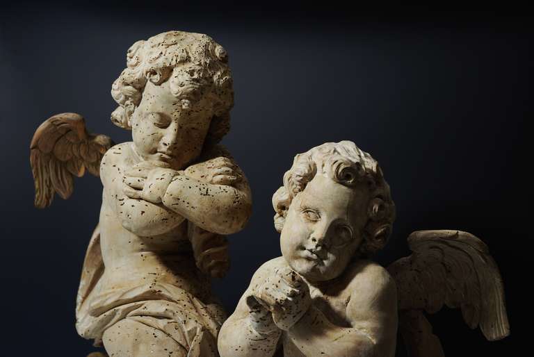 An exceptional pair of mid-17th century carved lime wood winged cherubs, possibly Italian. This pair of figures have a very calming influence when you look at them, almost angelic, and they appear to give you feelings of tranquility and serenity.