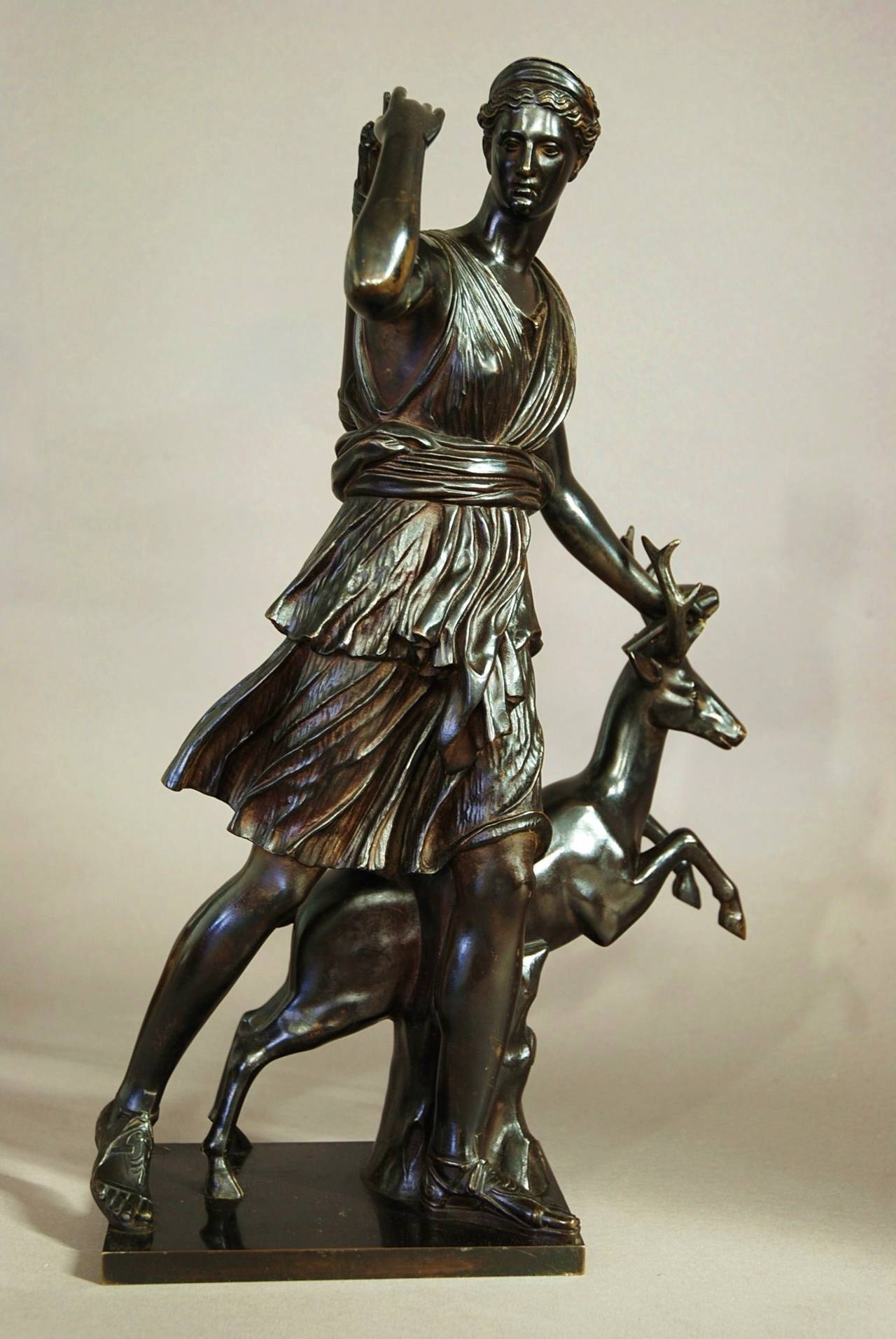 A mid 19th century bronze figure 'Diana of Versailles' or 'Diana the Huntress' after the antique, taken from the original large marble sculpture in The Louvre, Paris.

In this bronze, Diana is portrayed as the huntress with a vibrant, young male