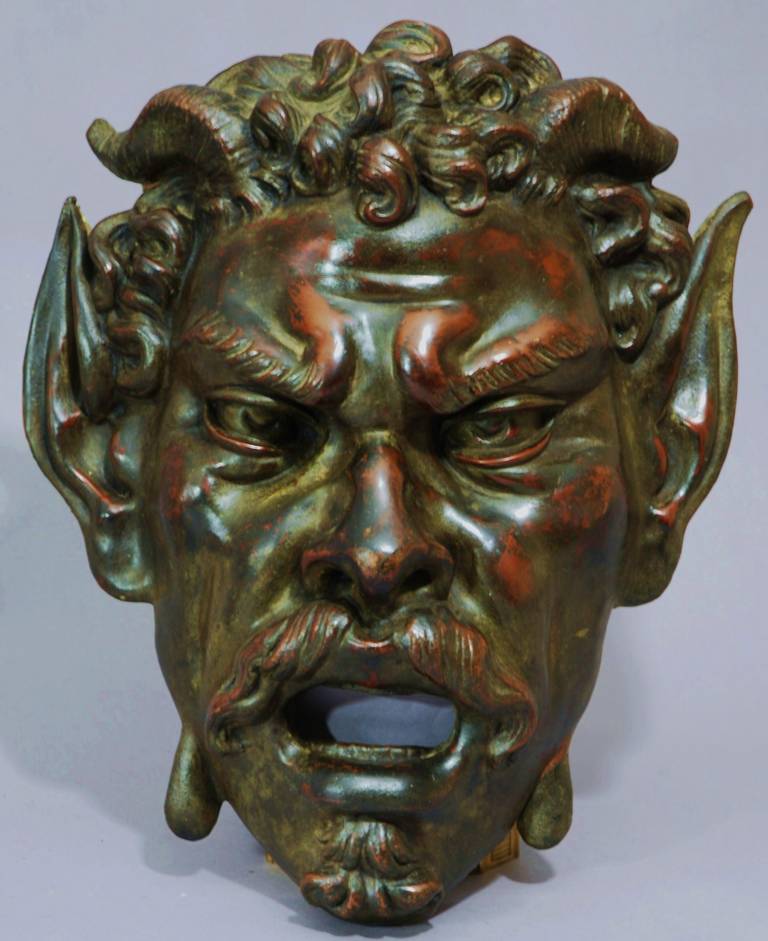 Highly decorative Continental mid-19th century bronzed copper satyr mask, of large proportions and of exceptional quality.

The satyr is part human, part goat, usually having small horns and pointed ears. He is often depicted as an attendant to