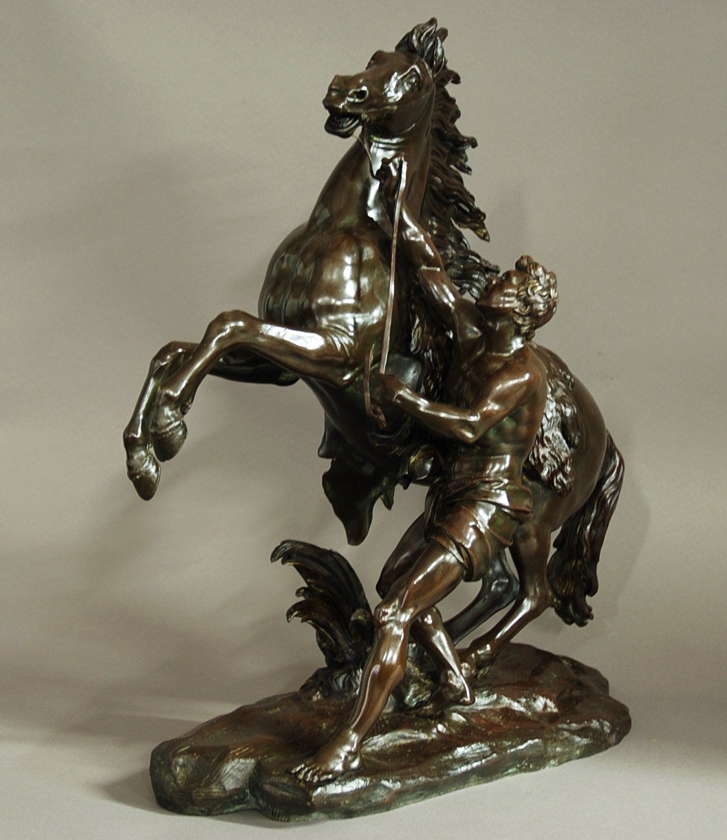 A late 19th century fine quality bronze Marly horse with his trainer, after Guillaume Coustou the Elder.

The original pair of horses were carved from marble and made for the Chateau de Marly between 1740-1745 and were then moved to the entrance