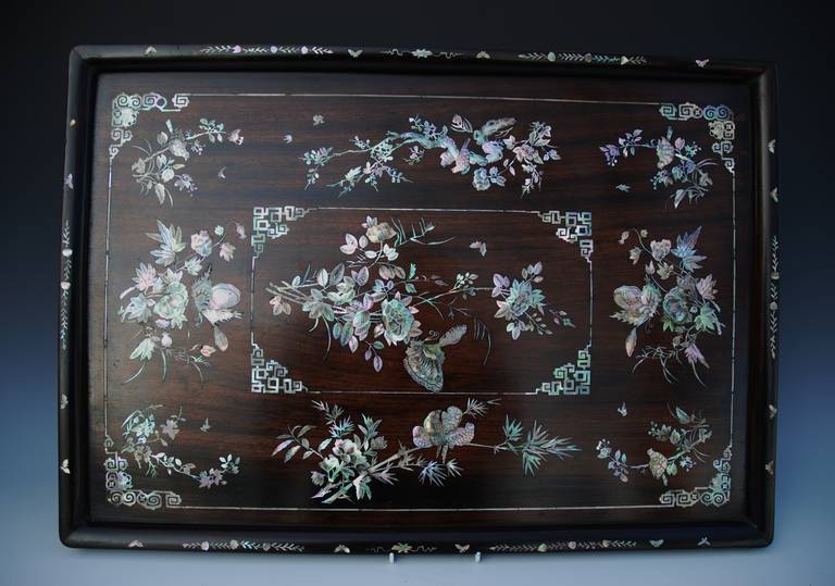 A late 19th century Vietnamese hardwood tray with inlaid and engraved mother of pearl, of superb quality. 

The edge of the tray is inlaid with leaf and flower decoration with butterflies. 

The tray has a mother of pearl inlaid border with  key