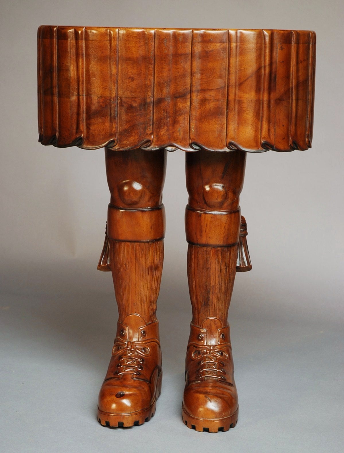 A highly decorative and quirky hardwood Scotsman's legs and kilt table - legs 11 !!

The top is in the form of a Scotsman's kilt with a pair of legs as the base, carved in the form of traditional Scottish attire. 

This table is in excellent