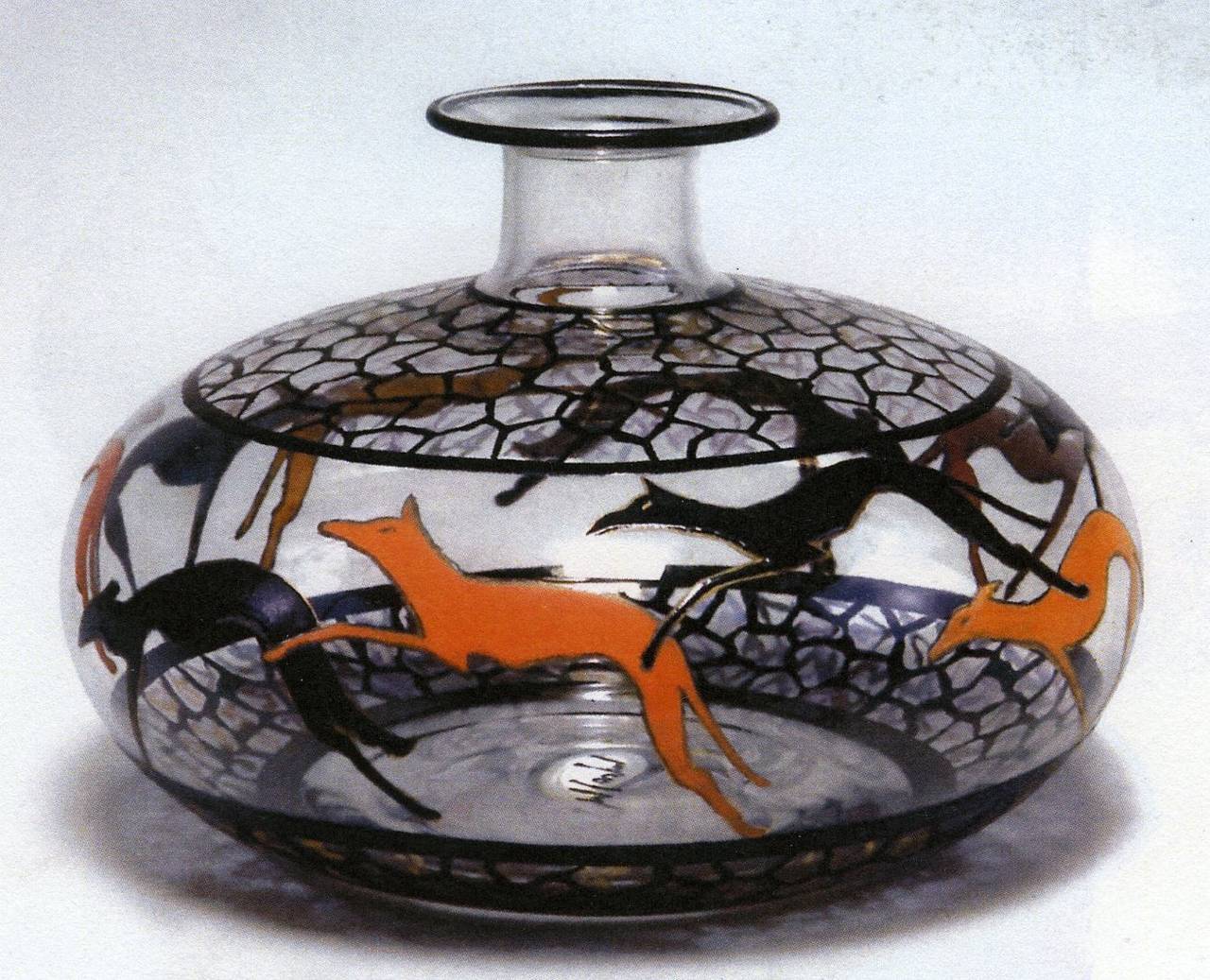 Clear glass with greyhound motives in orange and black-colored enamel.  
Signed underneath « MGoupy » in black enamel.
