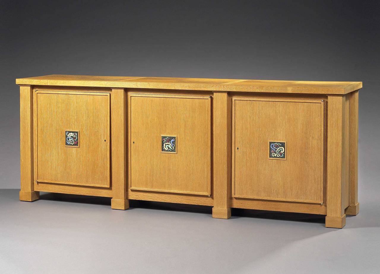 Quadrangular form with three doors, the central door opening to reveal five drawers, flanked by shelf-lined compartments. It should be noted the exceptional use of ceramic square plates with stylized pattern enhanced by bright and cheerful