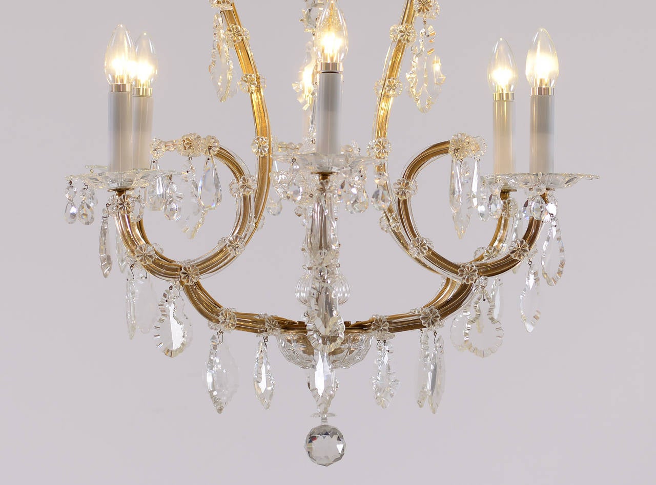 A very nice and charming chandelier with glass covered iron frames, nice hand-cut-glass hangings. The given drop is just for the chandelier.