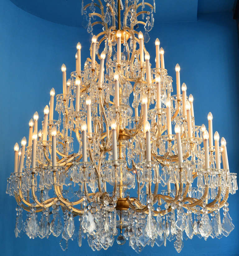 Extraordinary beautiful and very large parlor chandelier, with very big, hand-cut hangings from crystal glass. Gilded metal frame with layers of glass stripes. 76 flames. Executed circa 1950.