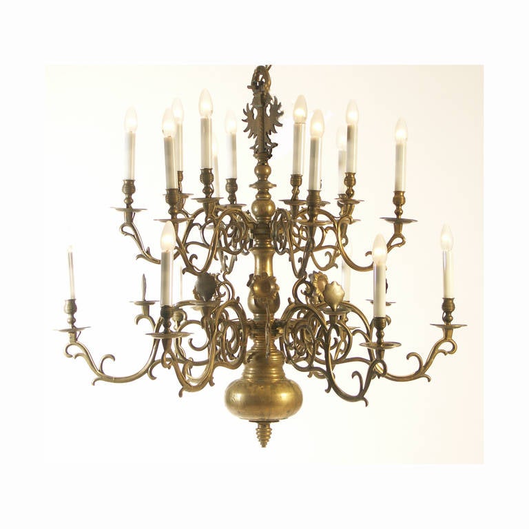 A very large bronze chandelier with casted arms and parts. Contrary to the 