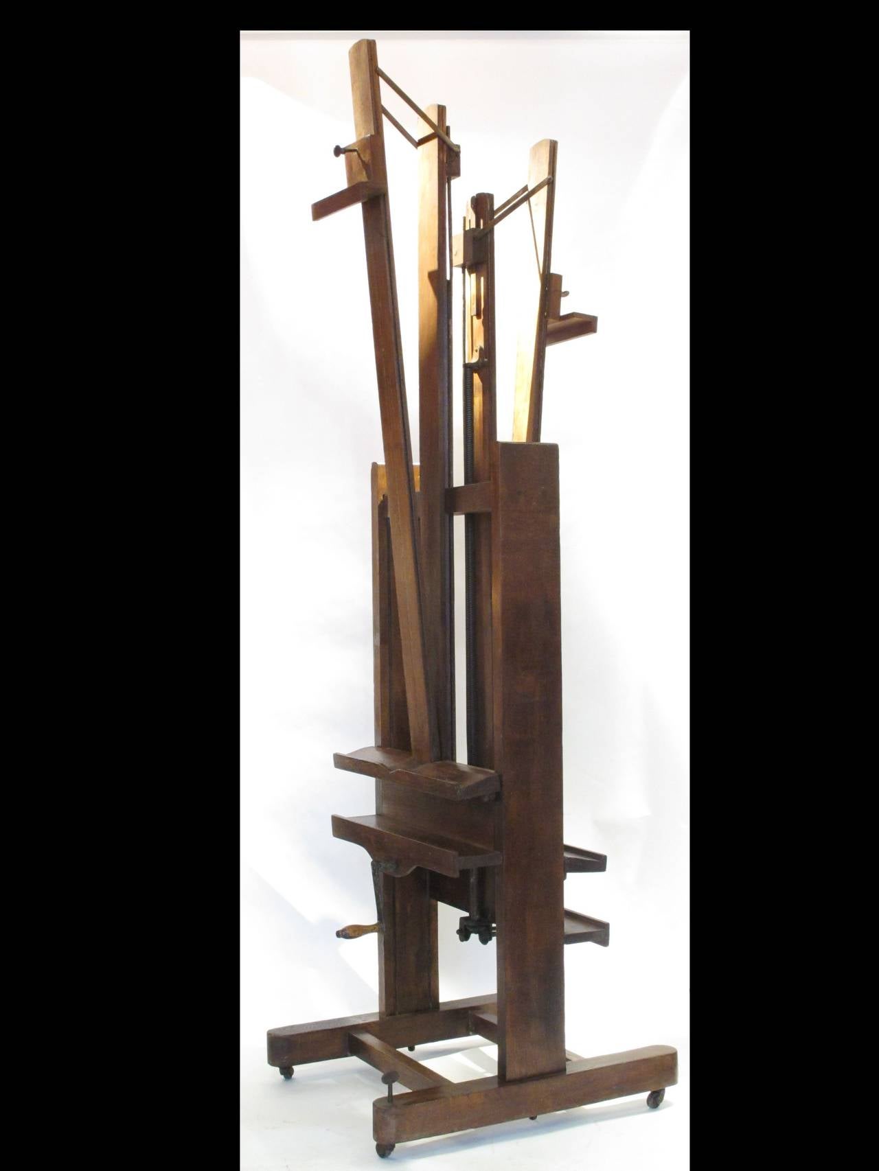 A oak studio/ artist's  adjustable easel, double sides and with 4 mechanisms.
Fully restored.

When closed 7.13 feet high.
Max. opening for a paintings 57 inch.