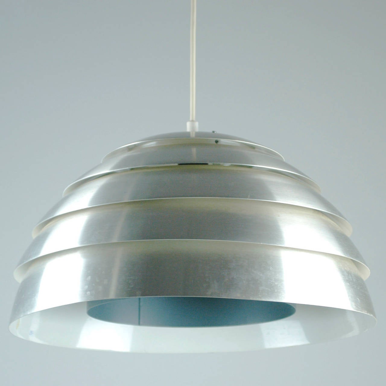 Elegant Scandinavian Modern Classic ceiling light in brushed aluminum with white lacquered interior designed by Hans Agne Jakobsson for AB Markaryd Sweden in the 1960s. Wonderful light effects. Original manufacturers label inside.
Perfect addition