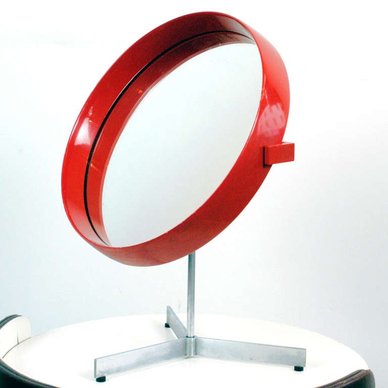 Amazing  table mirror in rare red lacquered version designed by Uno & Östen Kristiansson for LUXUS Vittsjö Sweden.
It features a Tripod steel base with rotating mirror; original label on the reverse! Overall in very good original condition.
Perfect