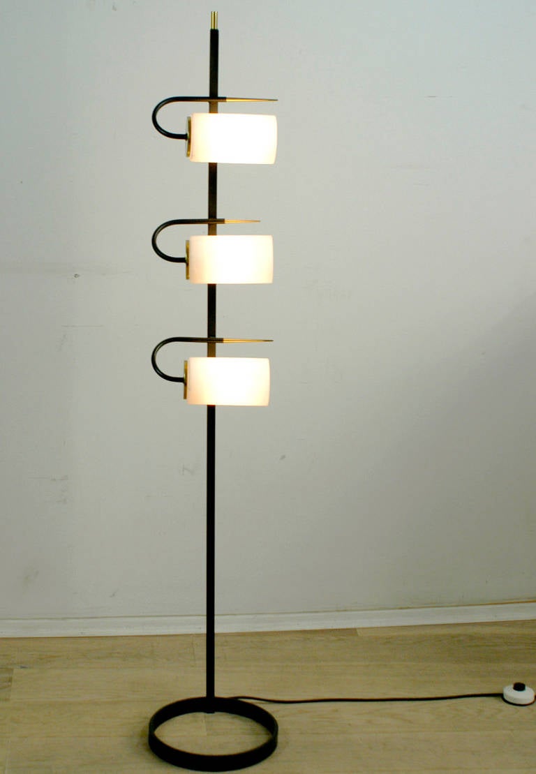 Rare and elegant Italian 1950s Floorlamp in the style of Stilnovo. Black lacquered iron with brass details and three opaline glass shades. Perfect addition to any mid century modern interior!