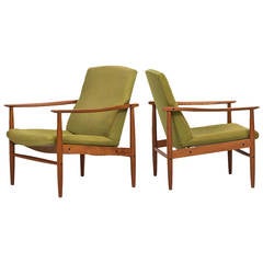Mid century pair of easy chairs in teak probably produced in Denmark
