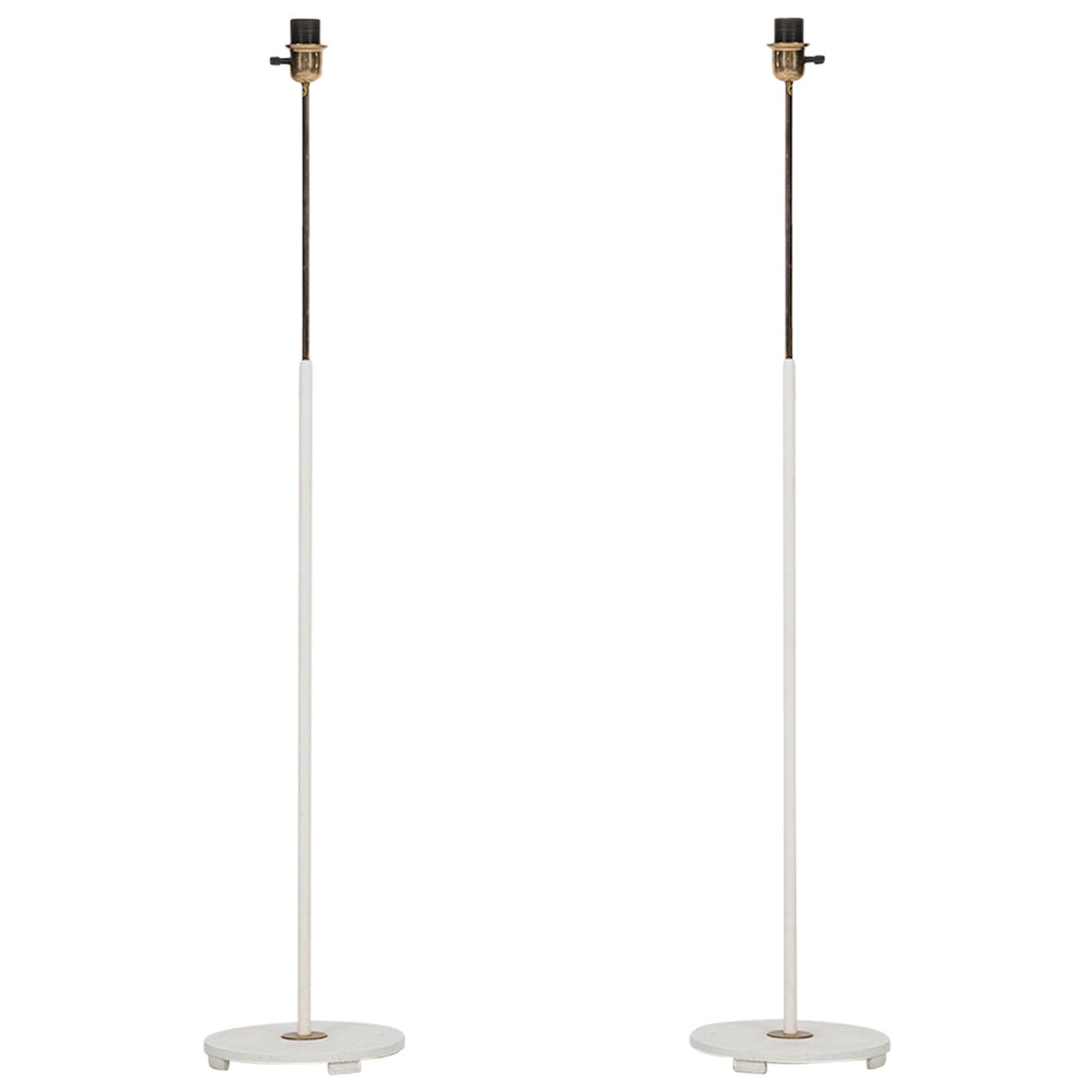 A pair of white floor lamps by ASEA in Sweden