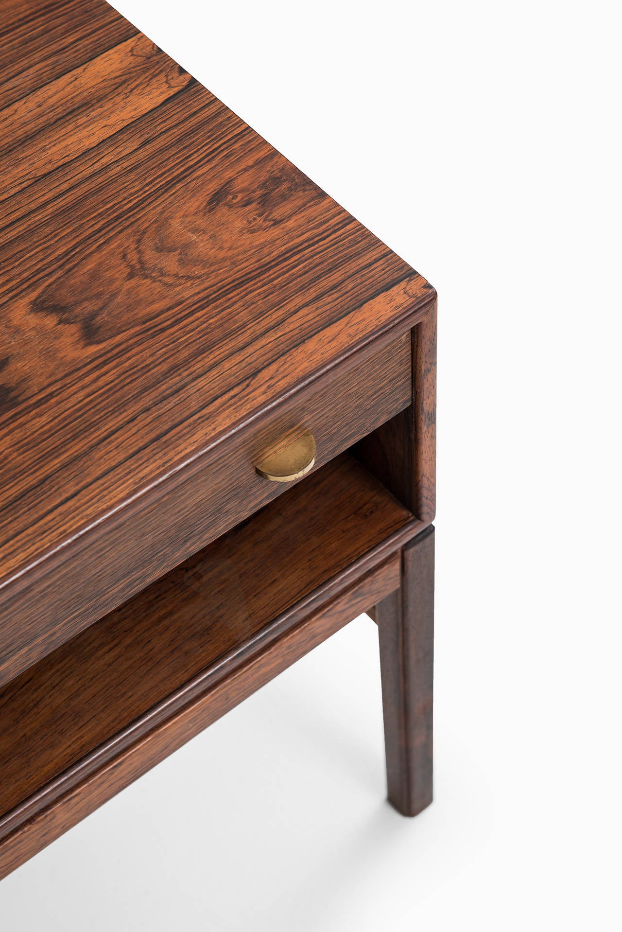 A pair of freestanding side or bedside tables in rosewood and brass designed by Sven Engström & Gunnar Myrstrand. Produced by Tingströms in Sweden.