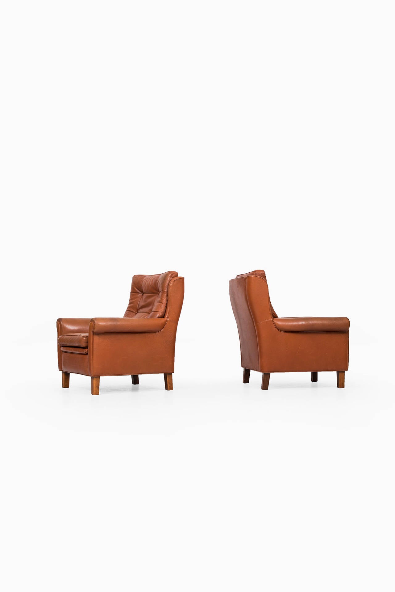 A pair of easy chairs in brown buffalo leather designed by Arne Norell. Produced by Arne Norell AB in Aneby, Sweden.