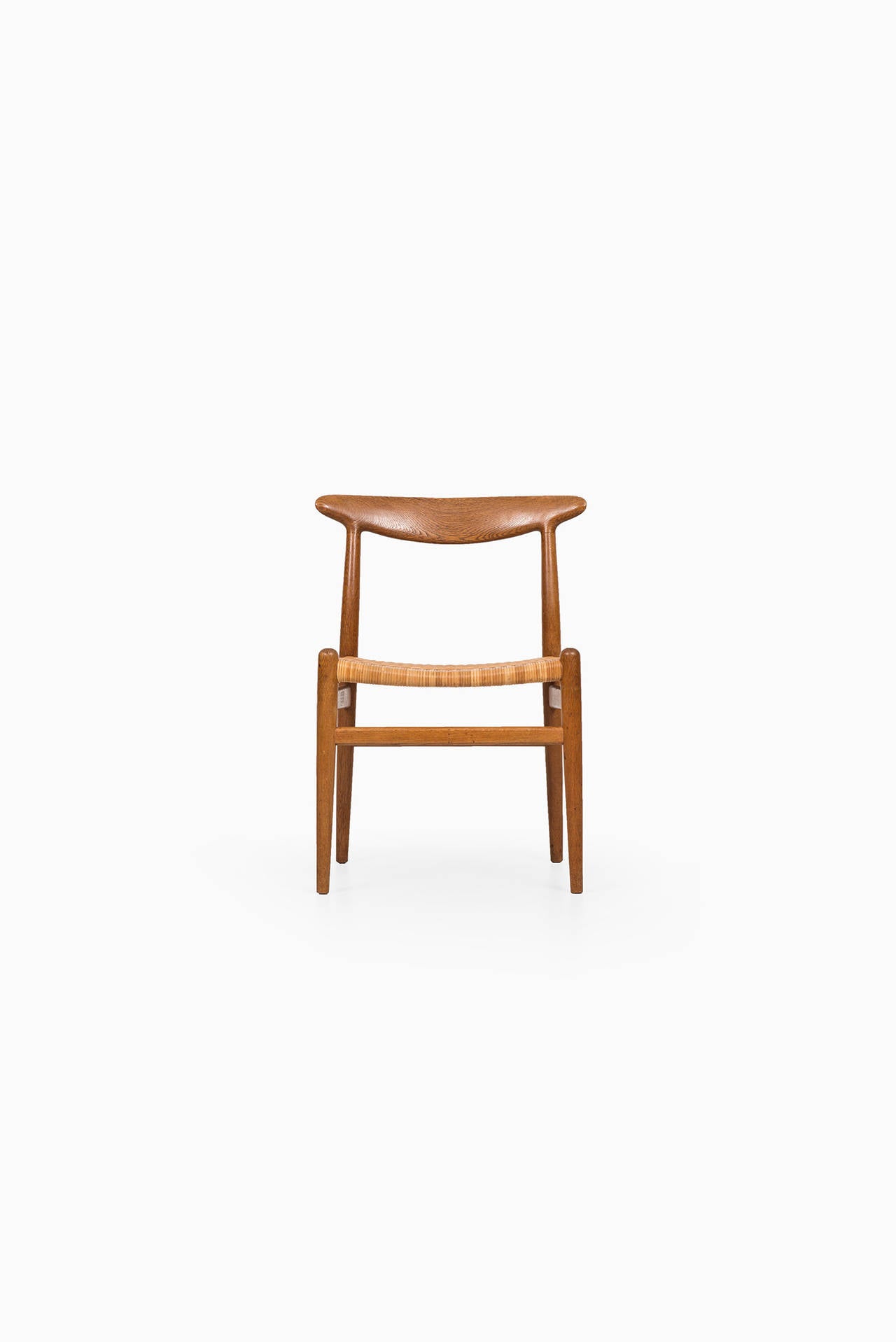 Set of four rare Hans Wegner dining chairs model W2. Produced by C.M Madsen in Denmark.