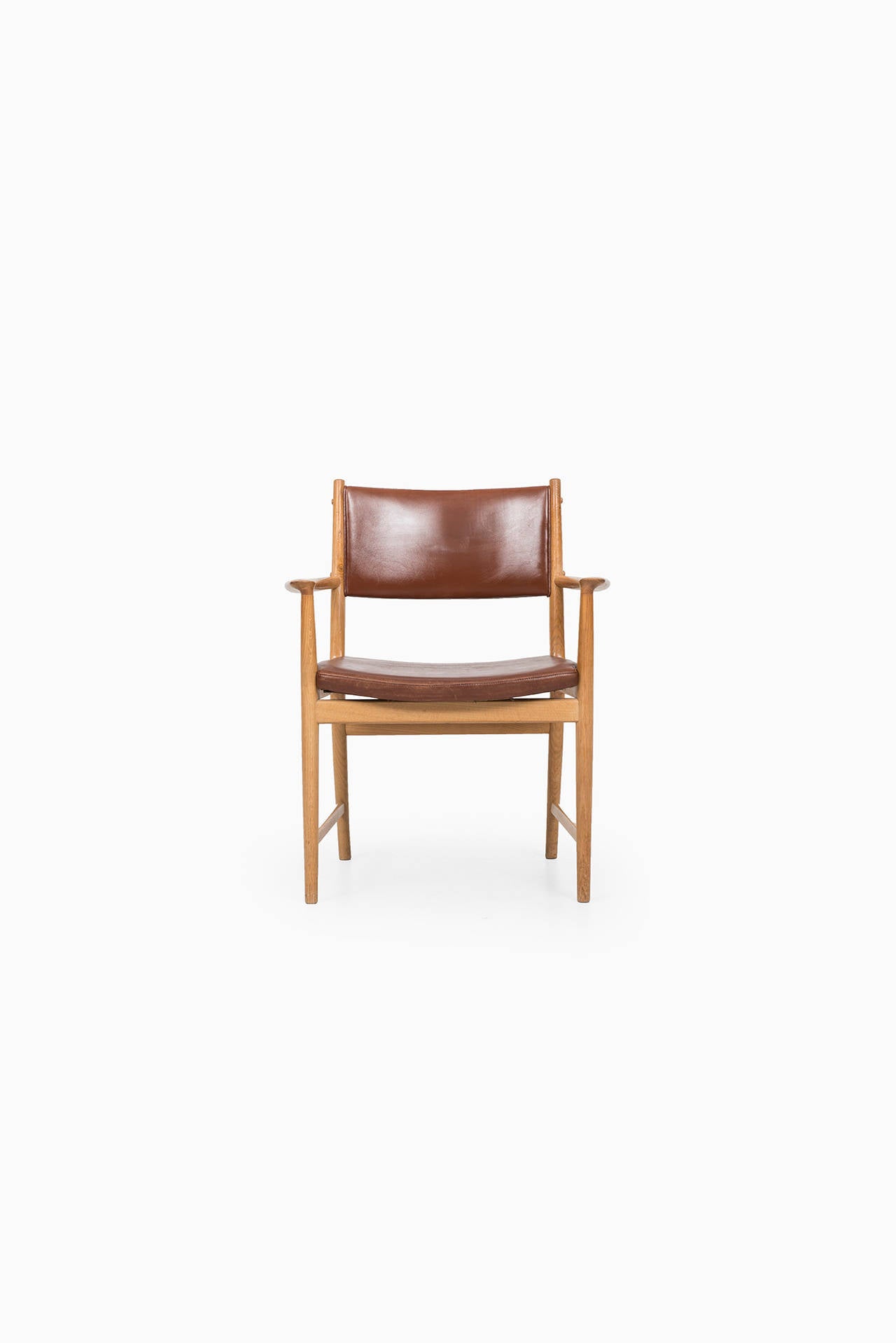 Rare set of six armchairs in oak and dark brown leather designed by Kai Lyngfeldt Larsen. Produced by Søren Willadsen in Denmark.