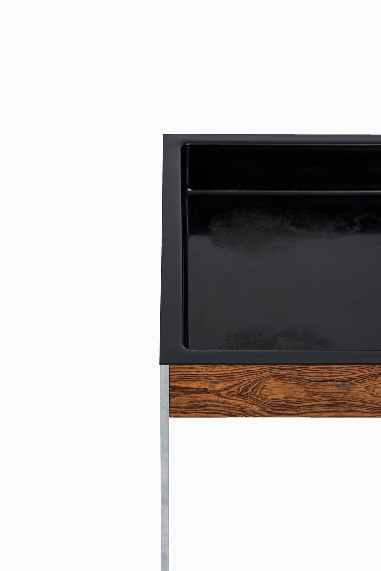 Rare plant stand in rosewood and steel designed by Uno & Östen Kristiansson. Produced by Luxus in Vittsjö, Sweden.