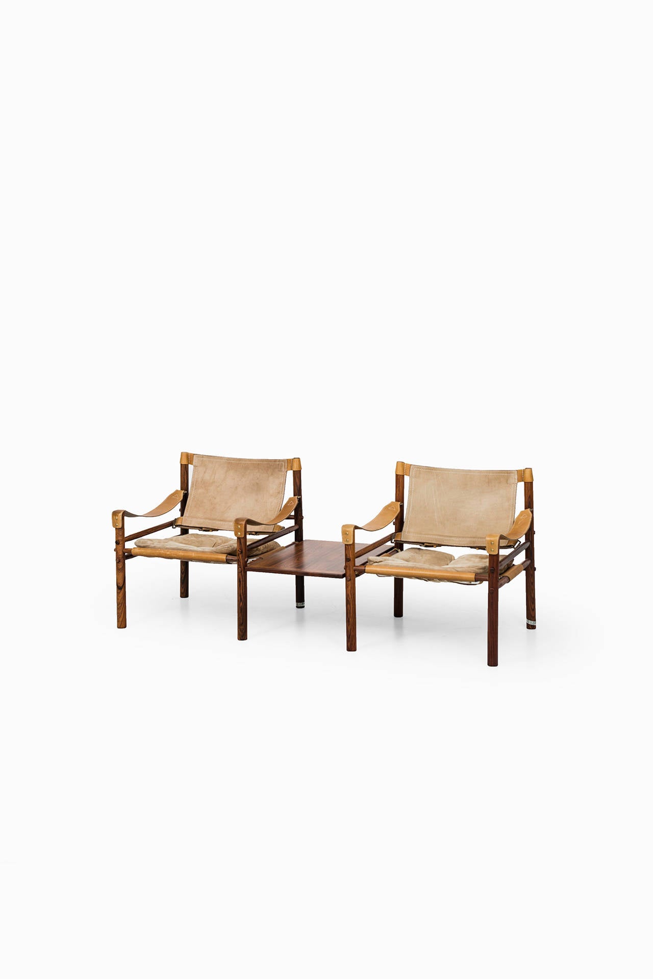 A set of 4 rare easy chairs model Sirocco / Scirocco with side tables in rosewood and original suede designed by Arne Norell. Produced by Arne Norell AB in Aneby, Sweden.