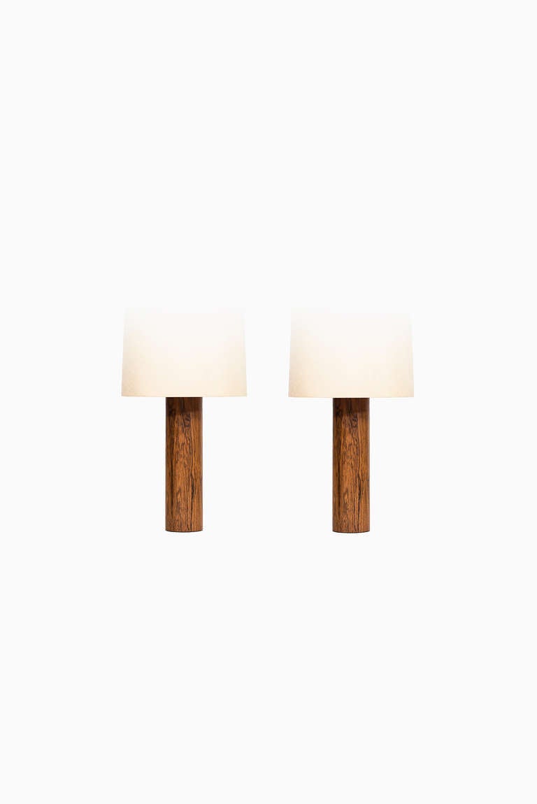 Rosewood table lamps in the manner of Uno & Östen Kristiansson. Probably produced by Luxus in Vittsjö, Sweden. Please note these are being sold without any lamp shades.