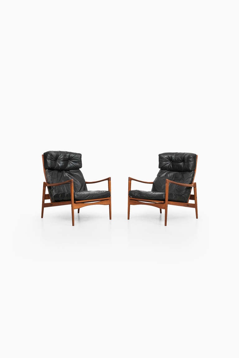 Rare pair of highback easy chairs model Örenäs designed by Ib Kofod-Larsen. Produced by OPE in Sweden
