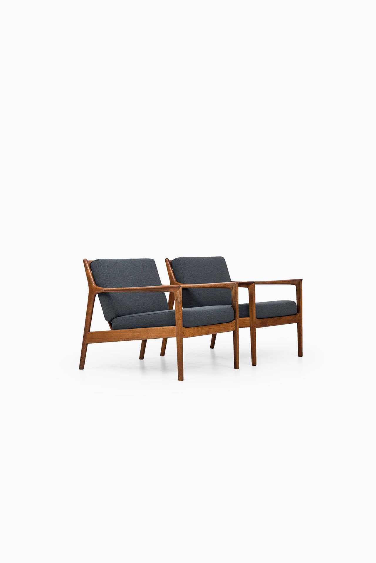 A pair of easy chairs model USA-75 designed by Folke Ohlsson. Produced by Dux in Sweden. Walnut and newly re-upholstered fabric. Matching sofa is also available.