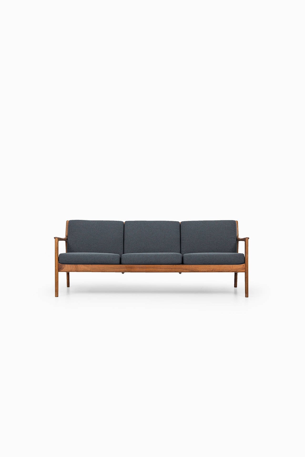Sofa model USA-75 designed by Folke Ohlsson. Produced by Dux in Sweden. Walnut and newly re-upholstered fabric. Matching pair of easy chairs is also available.
