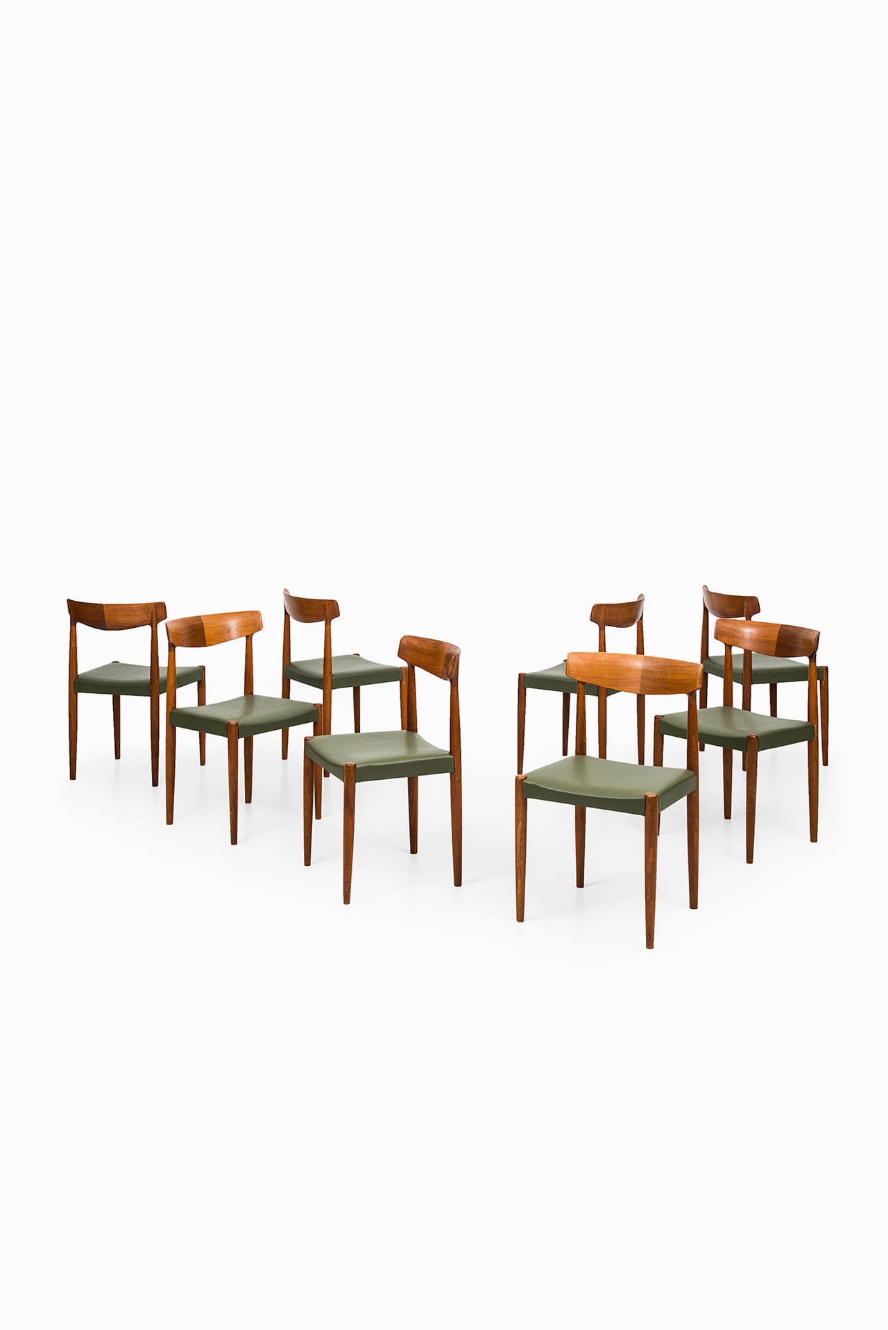 Rare set of eight dining chairs model 343 designed by Knud Færch. Produced by Slagelse møbelfabrik in Denmark. Massive teak and newly re-upholstered in green leather.