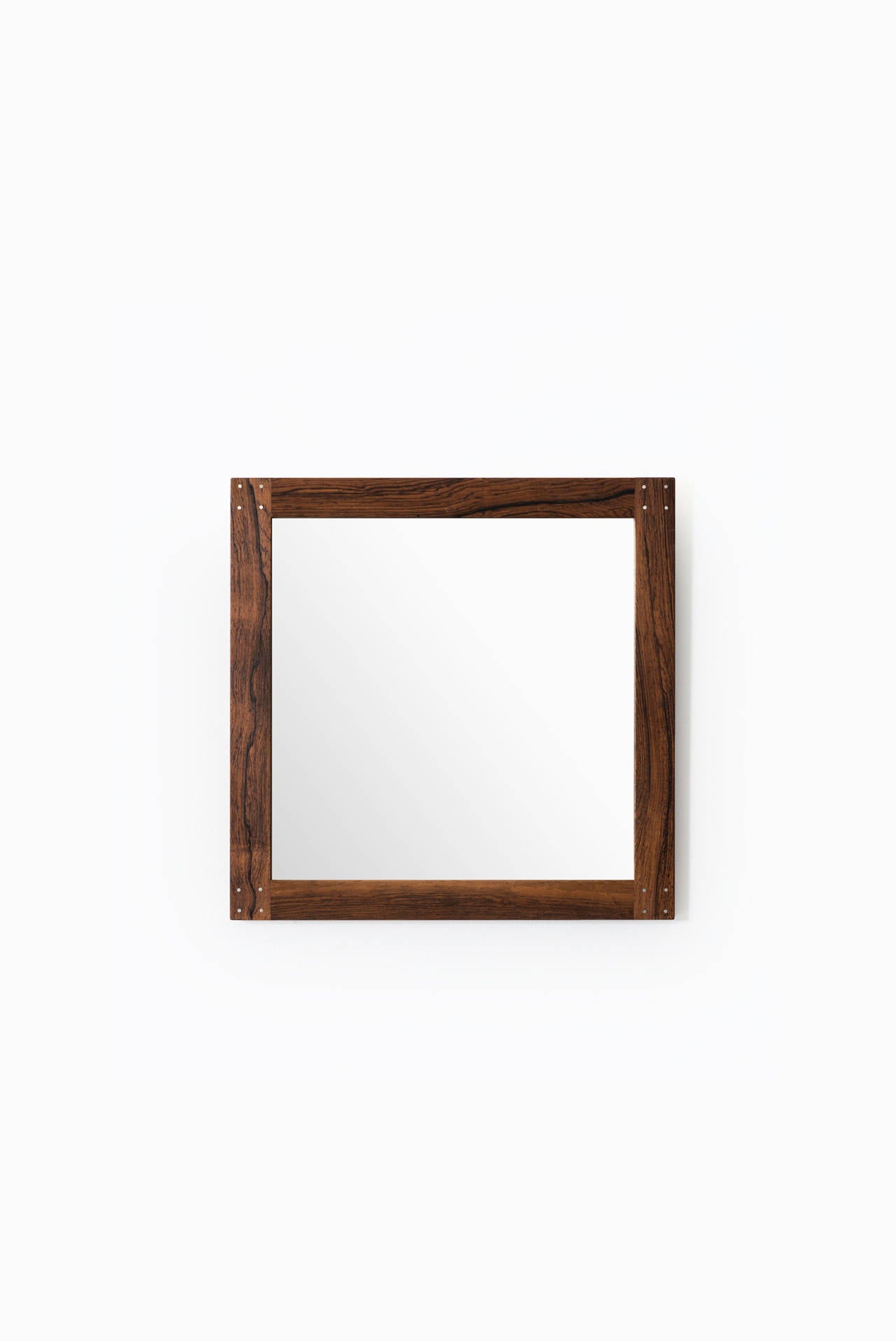 Rare mirrors in rosewood and nice silver detail designed by Uno & Östen Kristiansson. Produced by Luxus in Vittsjö, Sweden.
