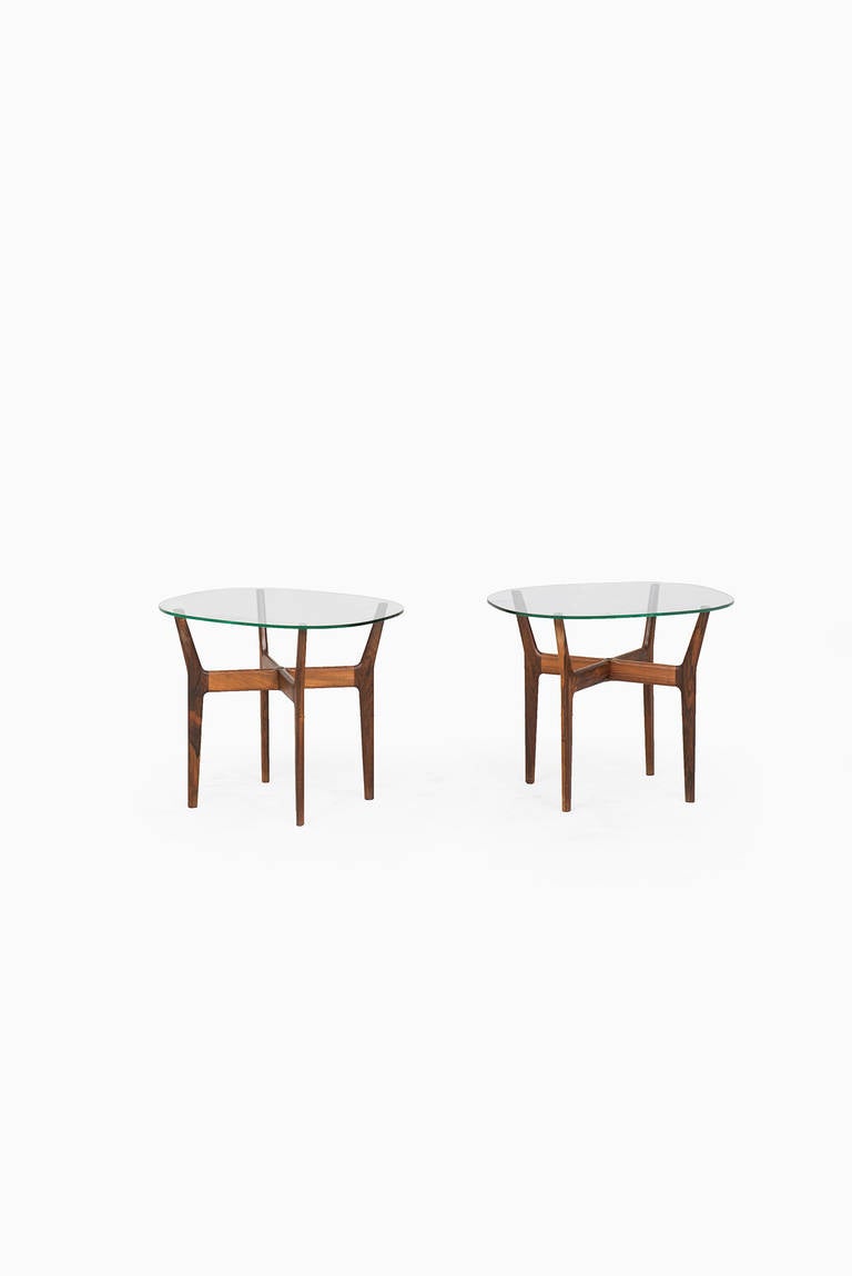 Rare pair of Alf Svensson Prisma side tables in rosewood and clear glass. Produced by Tingströms in Sweden.