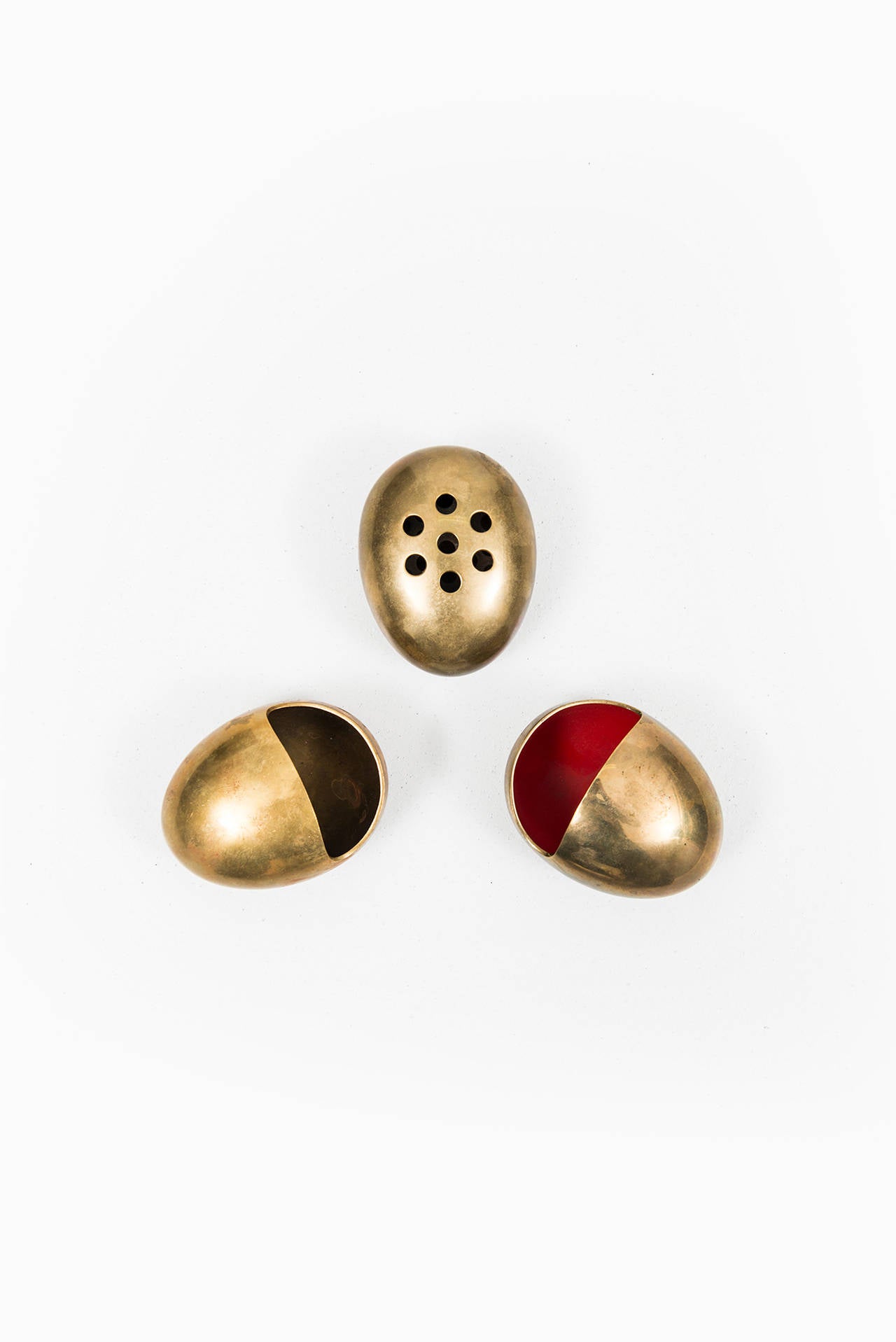 A set of two ashtrays and cigarette holder in brass by Cohr in Denmark.