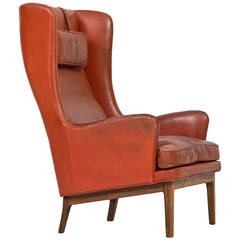 Arne Norell wingback easy chair in rosewood and leather by Norell AB in Sweden