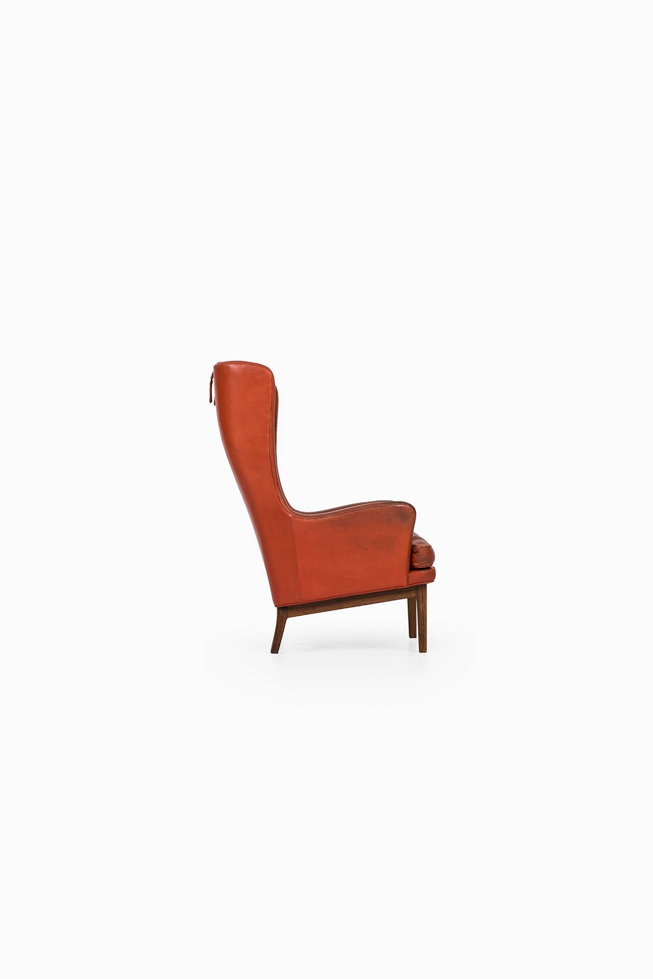 Swedish Arne Norell wingback easy chair in rosewood and leather by Norell AB in Sweden