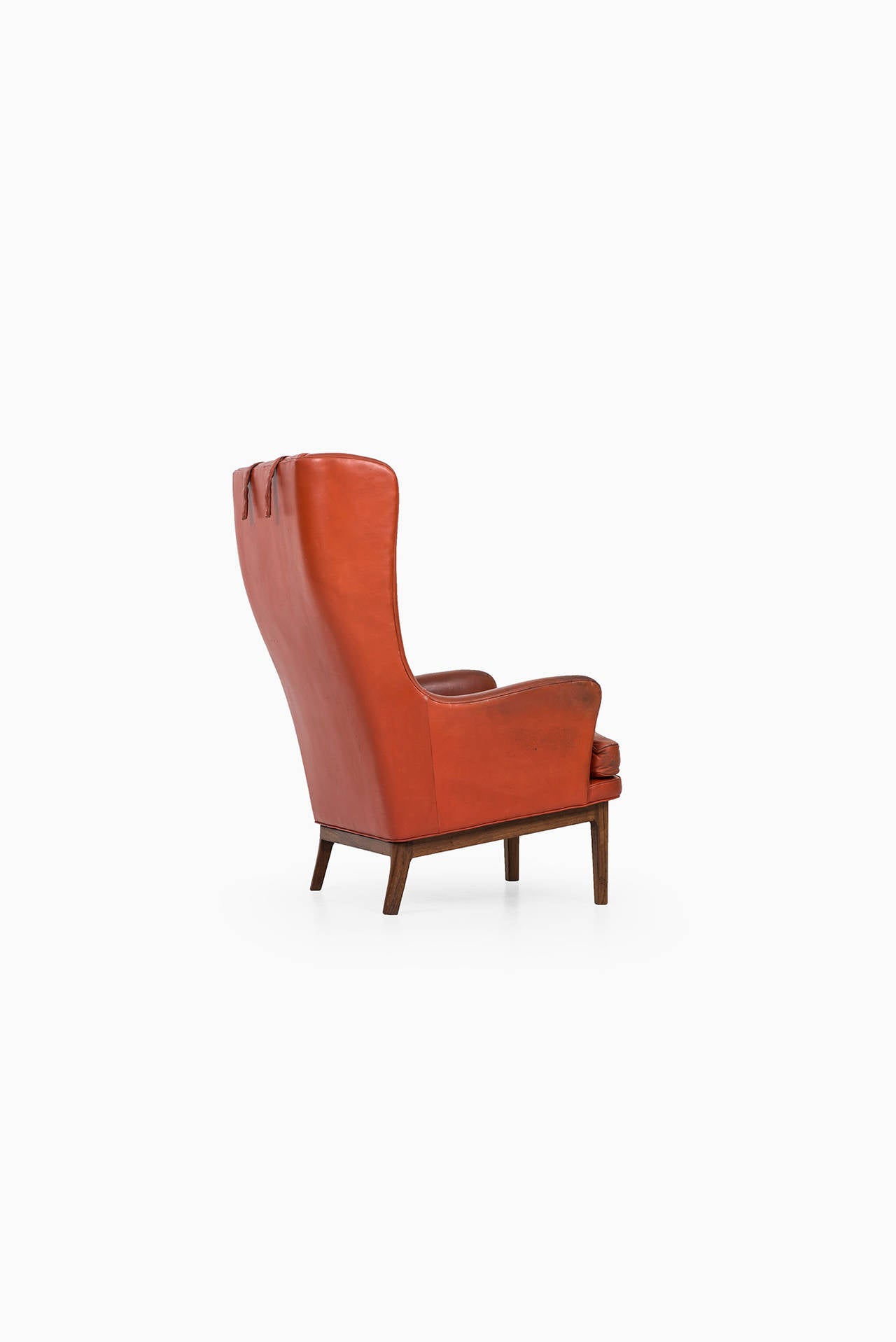 Mid-20th Century Arne Norell wingback easy chair in rosewood and leather by Norell AB in Sweden