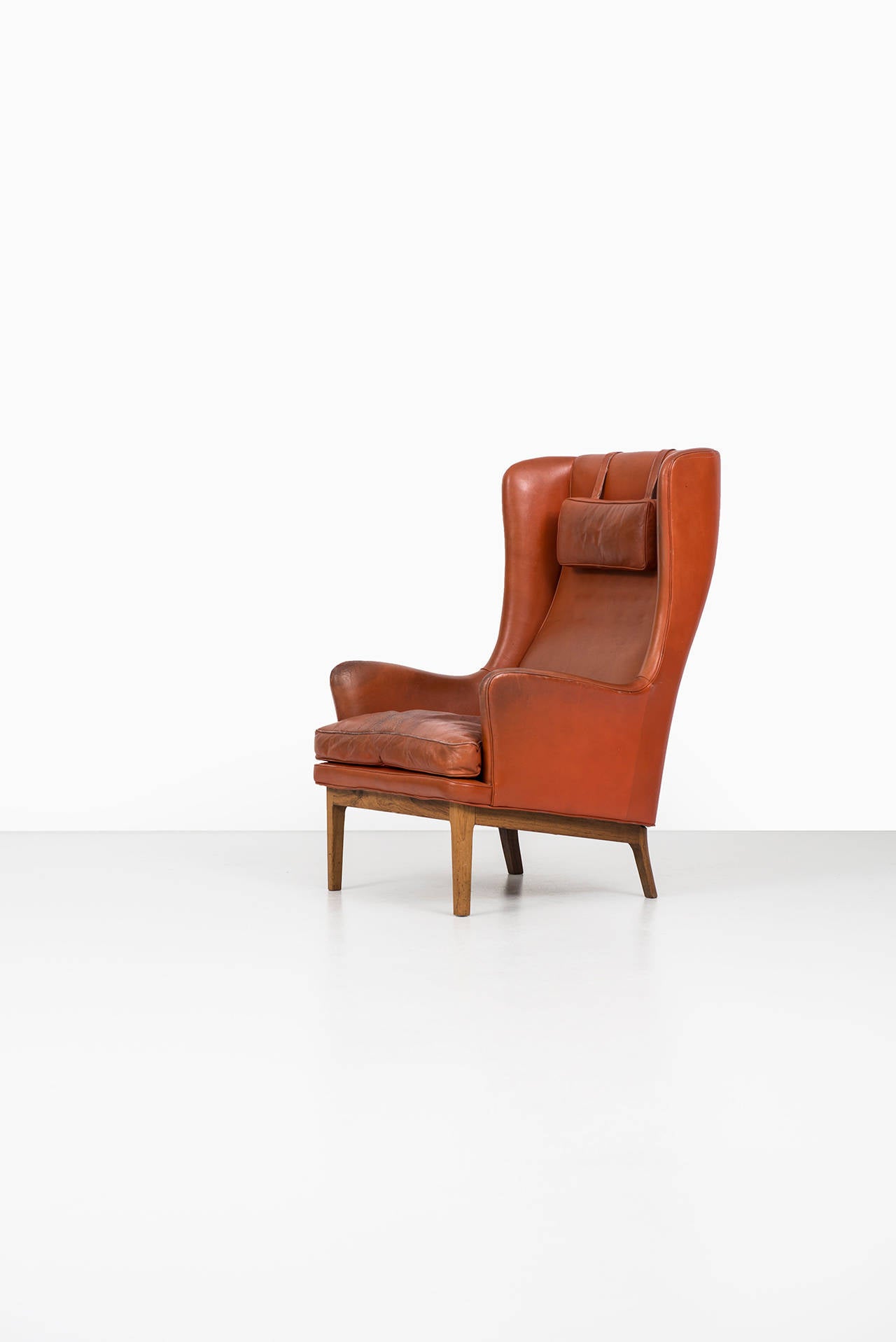 Rosewood Arne Norell wingback easy chair in rosewood and leather by Norell AB in Sweden