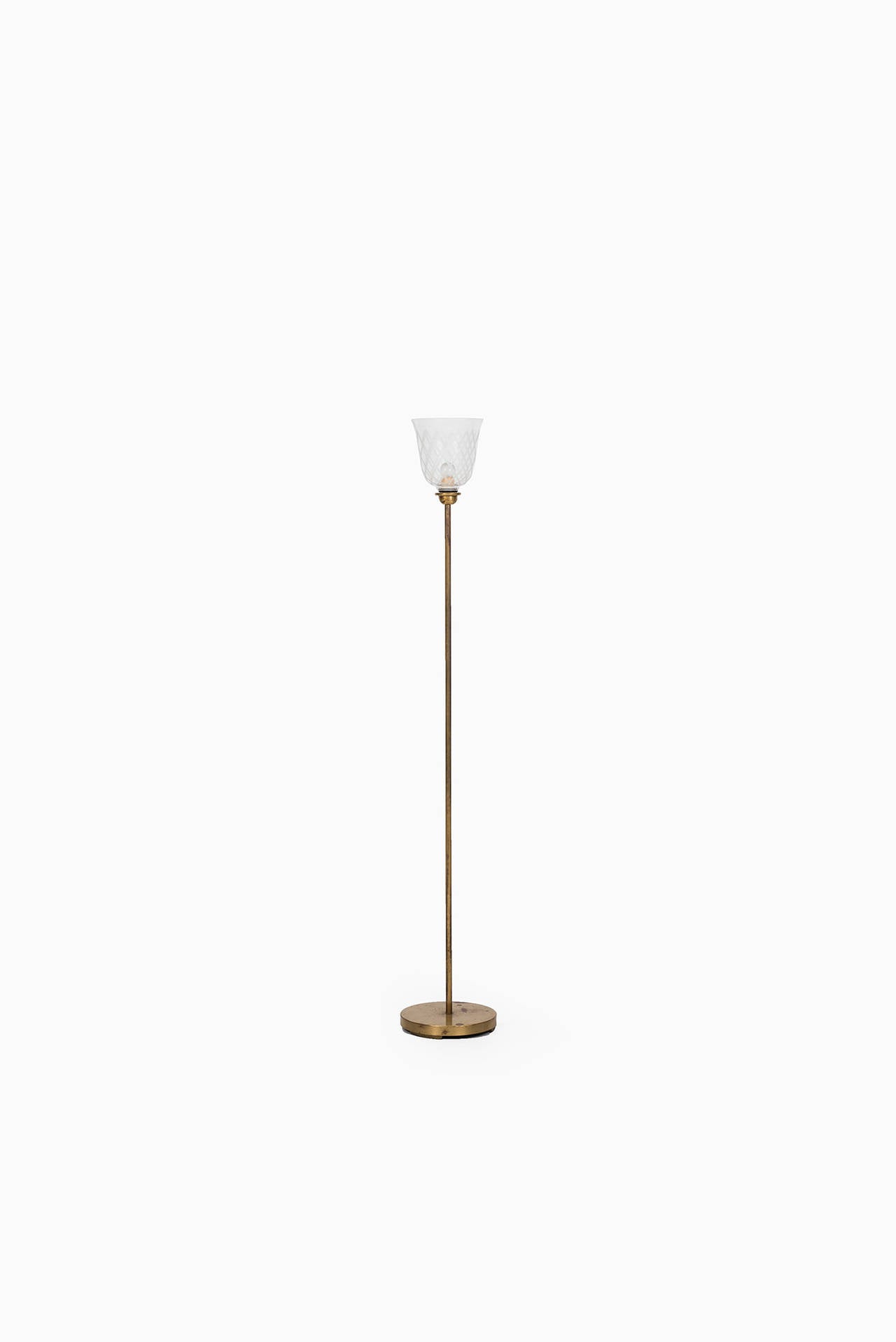 Rare floor lamp in brass and etched glass designed by Bo Notini. Produced by Glössner & Co in Sweden.