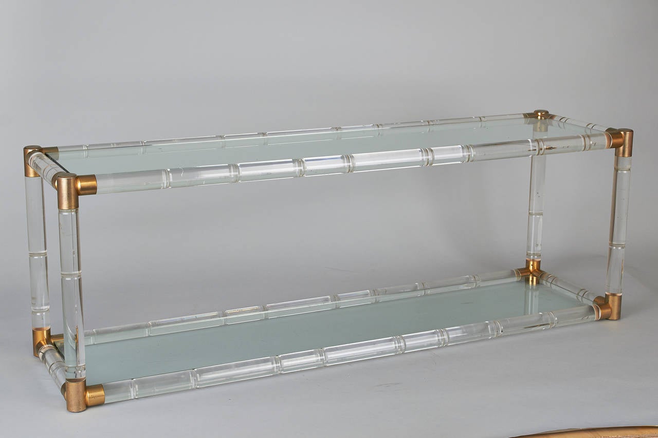 Mid Century Charles Hollis Jones Lucite Low Console Table with two Glass Shelves
Lucite in Faux Bamboo Style with Brass Accents.