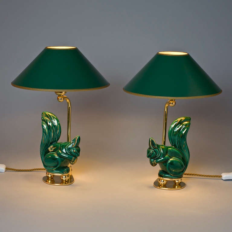 Green and gold  glazed Pair of Squirrels.  French Pottery, circa 1955.<br />
New mounted as  lamps. Lamp shades hand painted inside gold.<br />
Individual item.