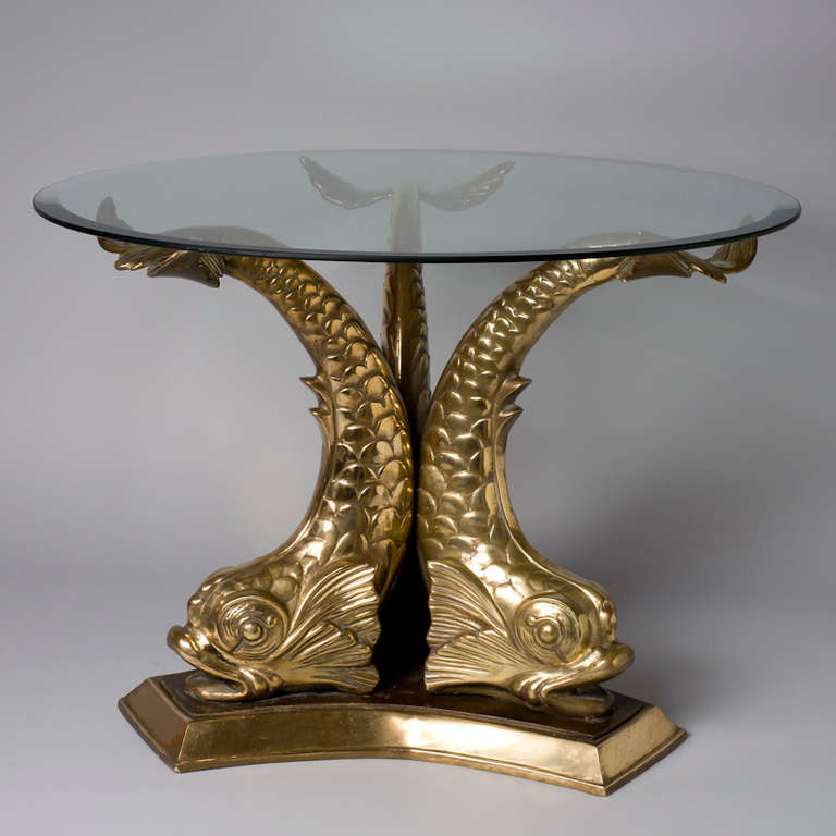 Beautiful victorian coffee table Three brass Dolphins on a wood and brass stand.
Measurement including glass top