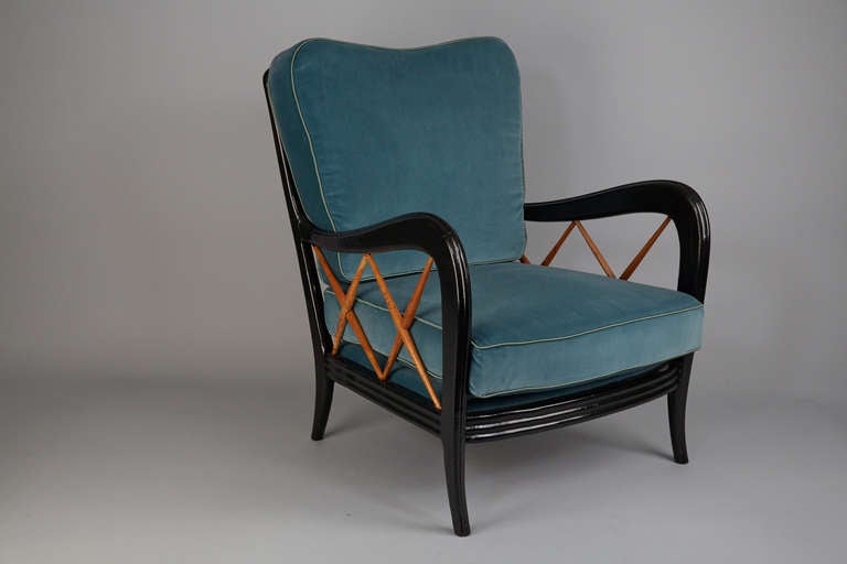 Armchair in the style of Paolo Buffa
ebonized frame with  wooden bars on the side and in the back. newly upholstered in blue-grey velvet.