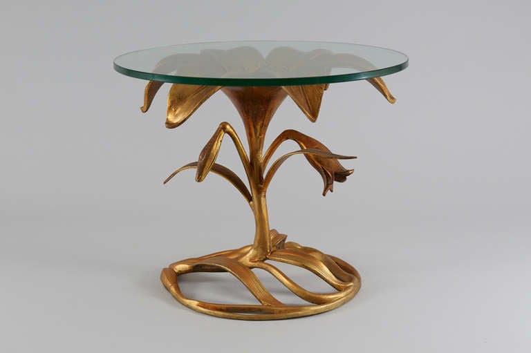 Arthur Court sculptural sidetable in gilded aluminum with glass top.