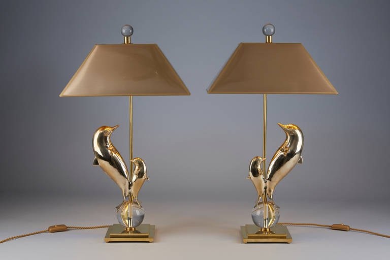 Midcentury brass dolphin figures. New mounted as lamps.
Pair is one of a kind.
Lampshades inside outside gold.
