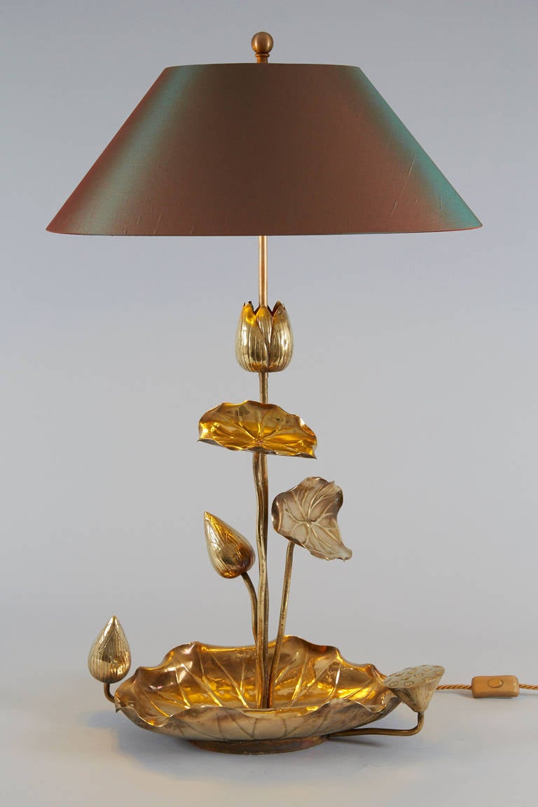 Elegant brass lotus lamp with rich details. Oval silk shade and newly wired.