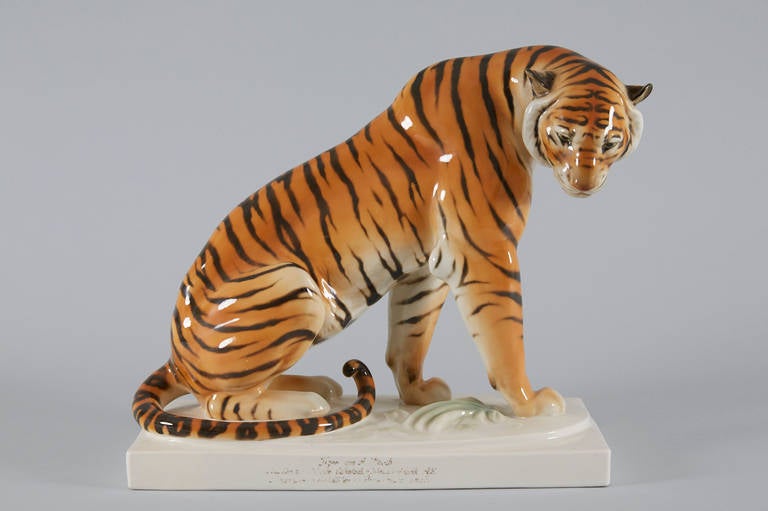 Sitting tiger by Arthur Storch for Schwarzburger Werkstätten, 1918.
Model number U 1167. Singed artist initials AS on the base.
Porcelain underglaze painting. This piece was probably part of a museum collection.