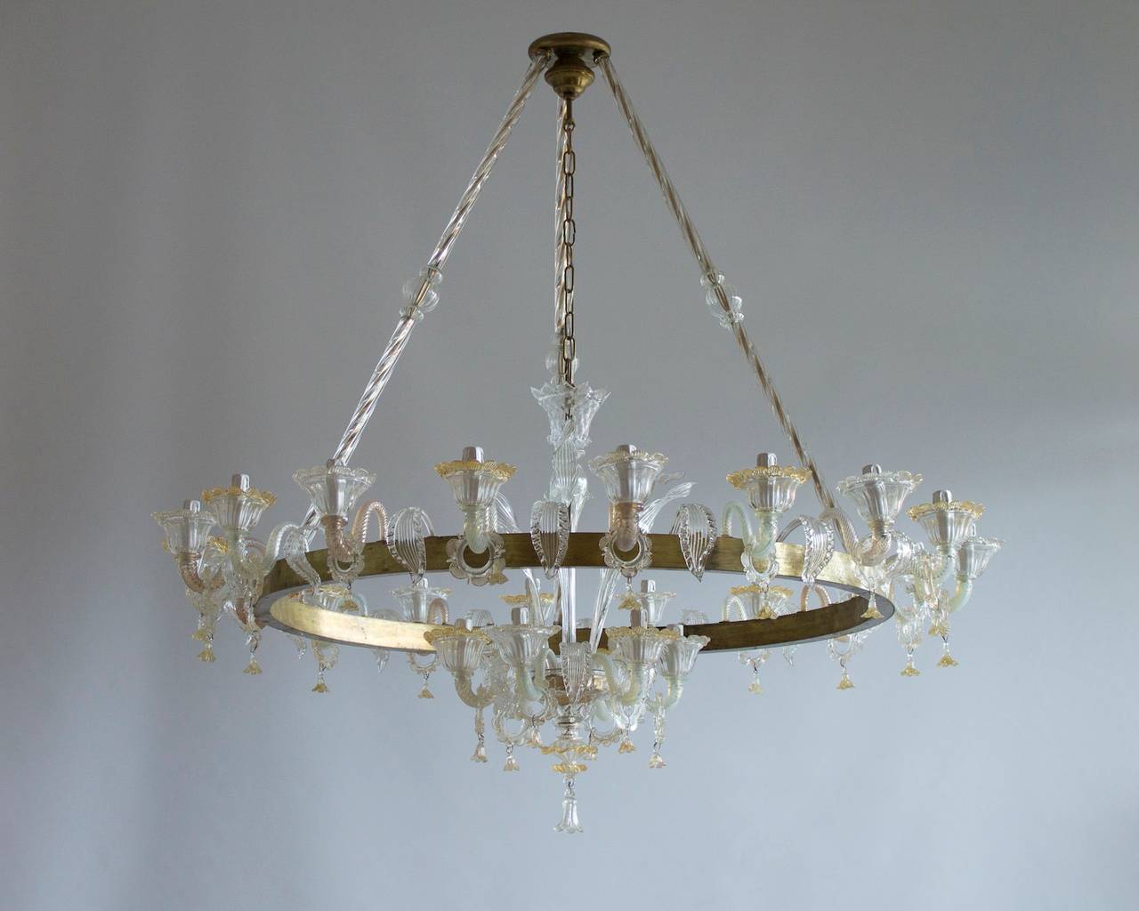 Amazing and rare chandelier, Italian Venetian, chandelier, blown Murano glass, antique gold and brass, in transparent and gold, white, opaline, composed by a circular brass frame with leafs and arms, with three long stems joining in a brass cup in