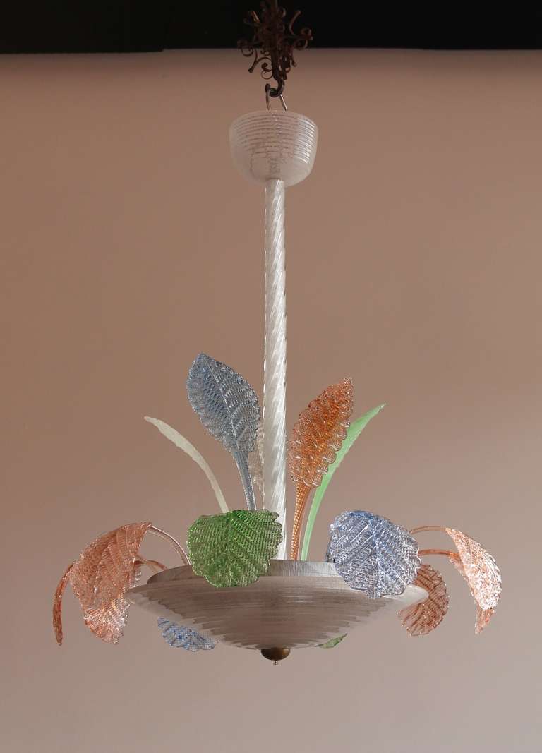 Italian Venetian Murano Glass Chandelier in white and multicolor, in very excellent condition, around 1950s, having a stem and a cup in white with circular stripes, and with multicolor leafs. The chandelier is 35.43 inches high, by 27.56 inches